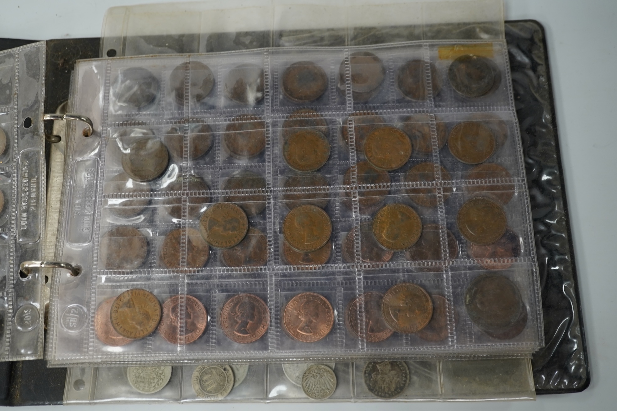 A collection of various coinage in an album, mostly George V to QEII